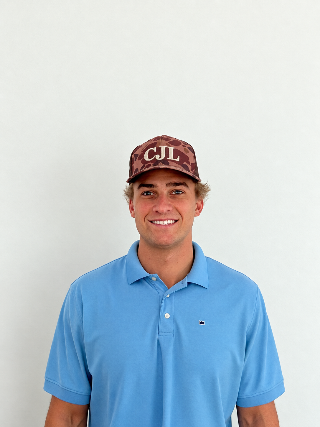 Cane Lige, founder of CJL Construction & Management, wearing a CJL hat